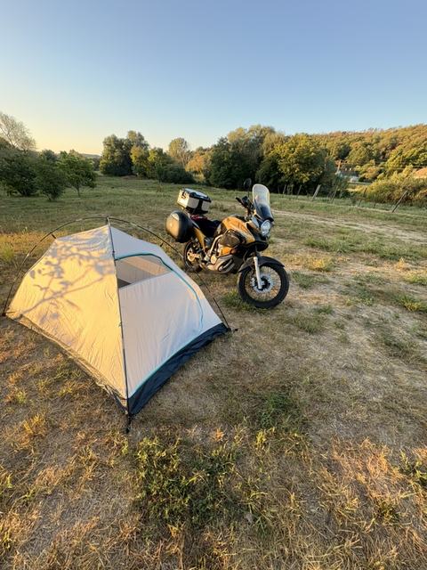 Namiot, motocykl i zachód słońca
